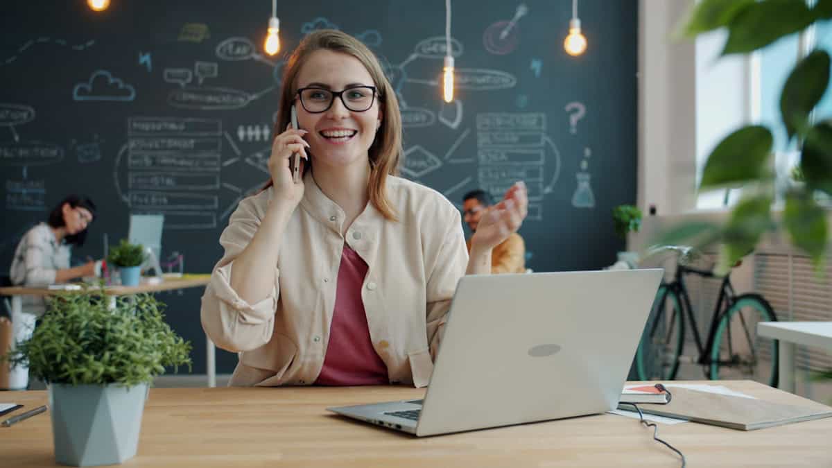 Kvinne i telefonsamtale på moderne kontor